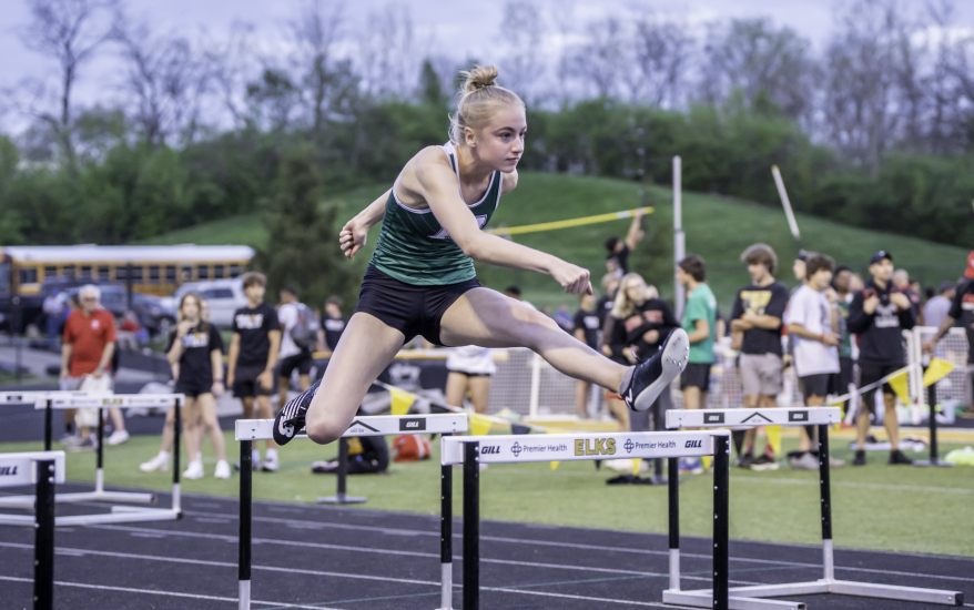 girl jumping hurdle